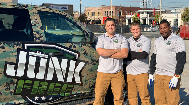 3 Junk Free LLC team members in front of branded truck
