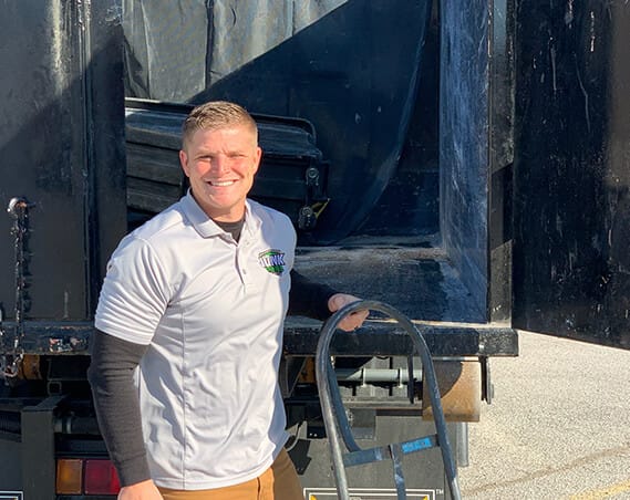 Junk Free LLC team member in front of truck