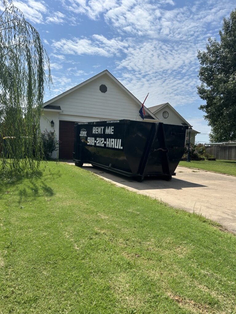 Junk Free 15-yard roll-off dumpster on a residential driveway in Jenks