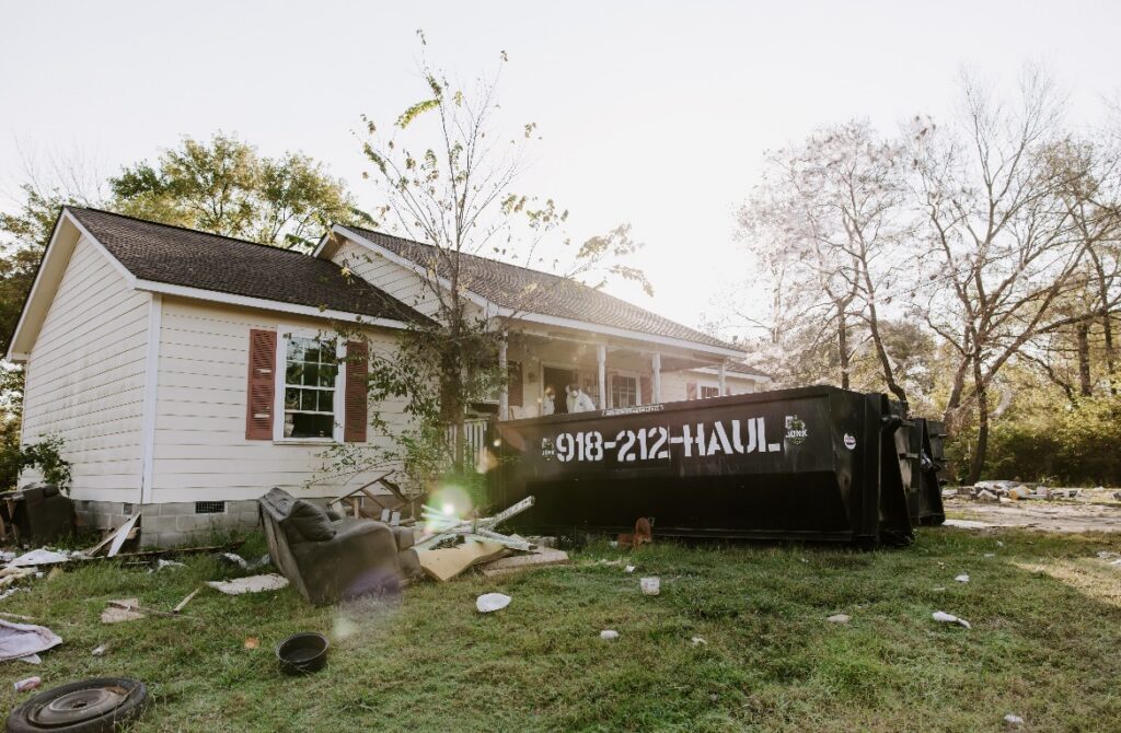 Junk Free 20-yard dumpster beside a house during a property cleanout