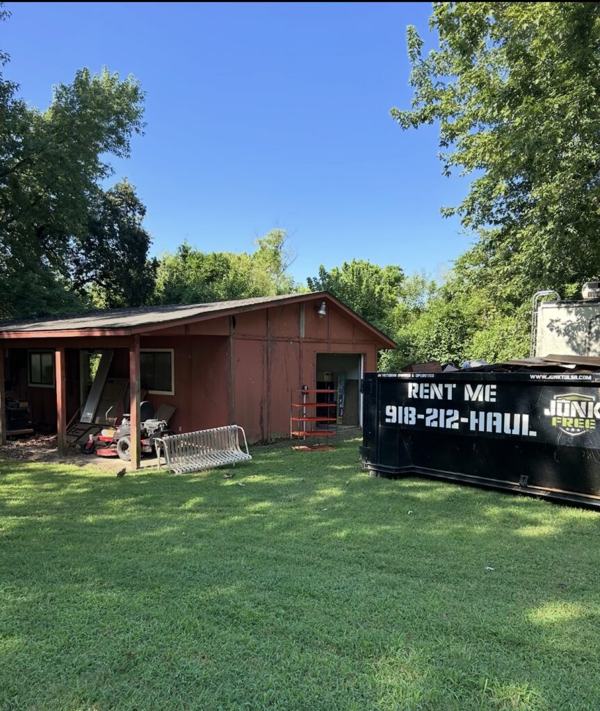 Junk Free 15-yard dumpster beside a house during a residential cleanup
