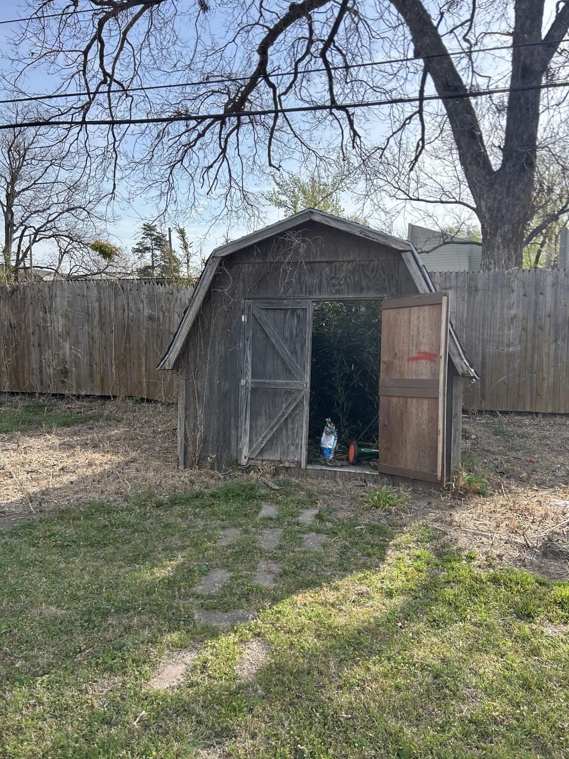 Old wooden backyard shed before demolition