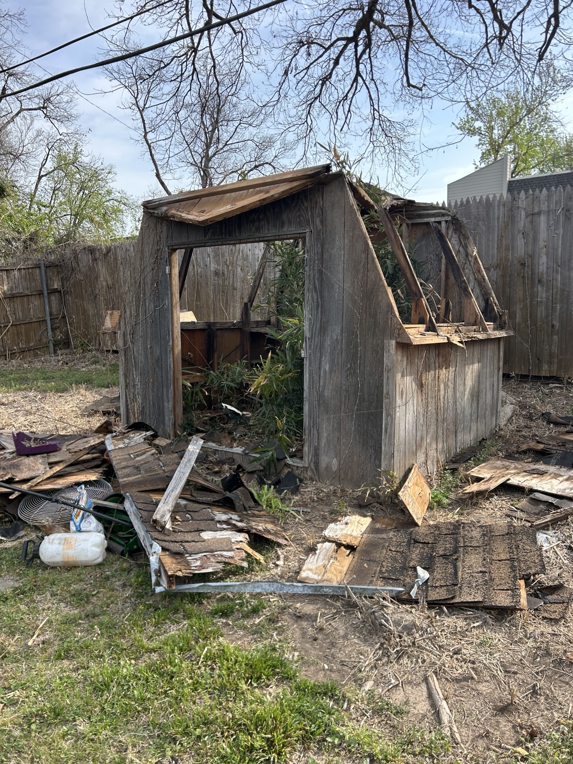 Old wooden shed partly dismantled during demolition